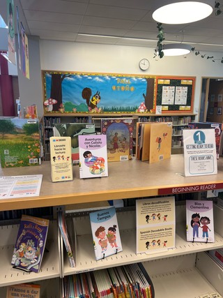Library shelving unit with books and educational materials.