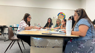 This photos shows Lucía in a working with a small group of teachers on implementing Hola Books in the classroom.